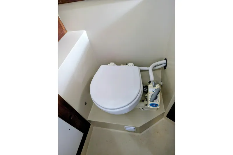 Slide: The Image of 1990 Catalina Capri 26 boat toilet with manual pump system. - 13
