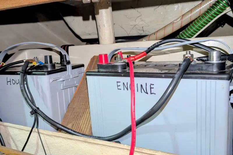 Slide: The Image of Batteries labeled "House" and "Engine" in a 1990 Catalina Capri 26 sailboat. - 14
