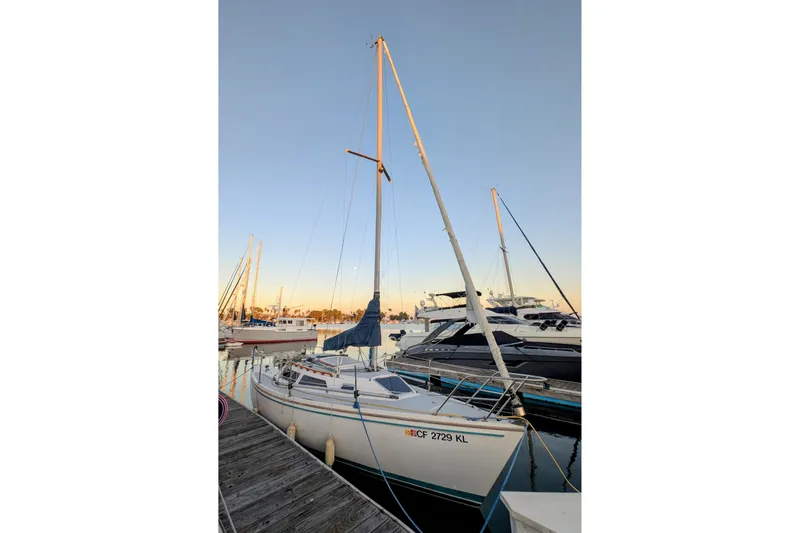 Slide: The Image of 1990 Catalina Capri 26 sailboat docked at marina during sunset. - 22