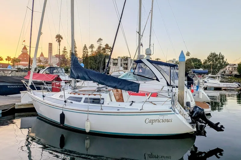 Slide: The Image of 1990 Catalina Capri 26 sailboat docked at marina during sunset. - 25