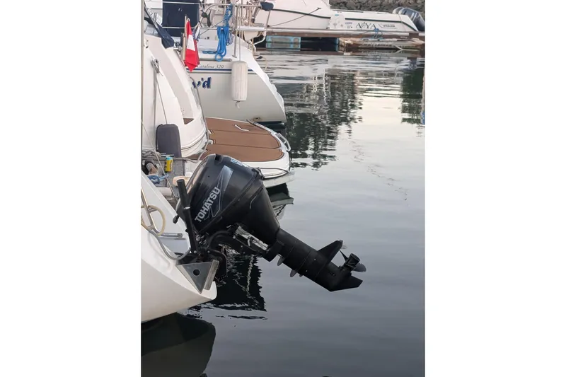 Slide: The Image of Outboard motor on a 1990 Catalina Capri 26 sailboat docked in a marina. - 26