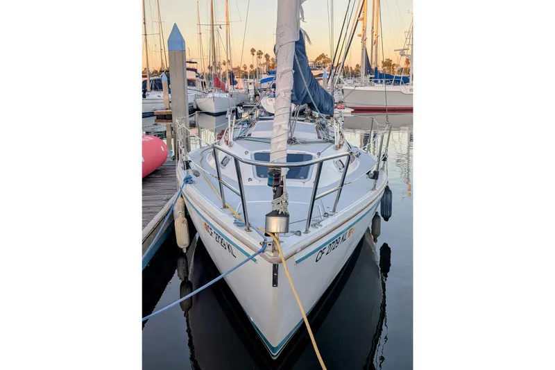 Slide: The Image of 1990 Catalina Capri 26 sailboat docked at marina, front view. - 27