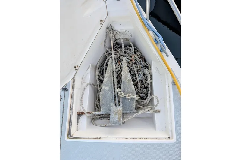 Slide: The Image of Anchor and ropes in the bow compartment of a 1990 Catalina Capri 26 sailboat. - 28