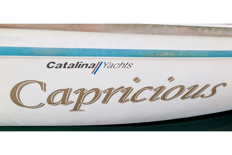 Slide: The Image of 1990 Catalina Capri 26 sailboat with "Capricious" name on hull. - 36