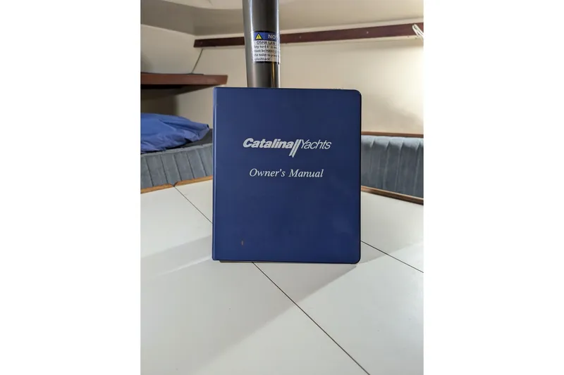 Slide: The Image of Catalina Capri 26 owner's manual on a yacht table, 1990 model. - 38