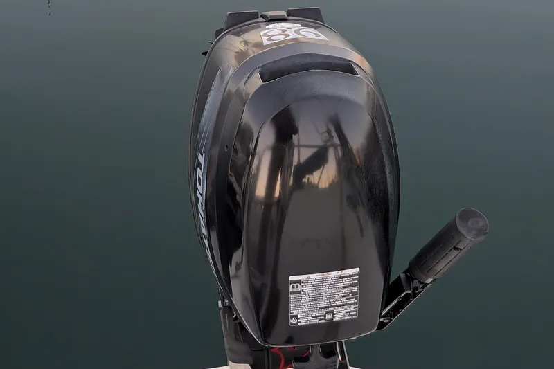 Slide: The Image of Outboard motor on a 1990 Catalina Capri 26 sailboat, reflecting on calm water. - 4