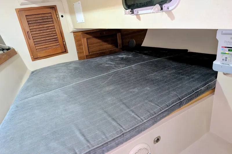 Slide: The Image of Interior cabin of a 1990 Catalina Capri 26 sailboat with a cozy sleeping area. - 6