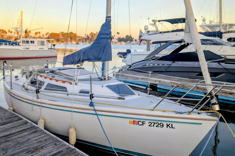 Slide: The Image of 1990 Catalina Capri 26 sailboat docked at marina during sunset. - 8