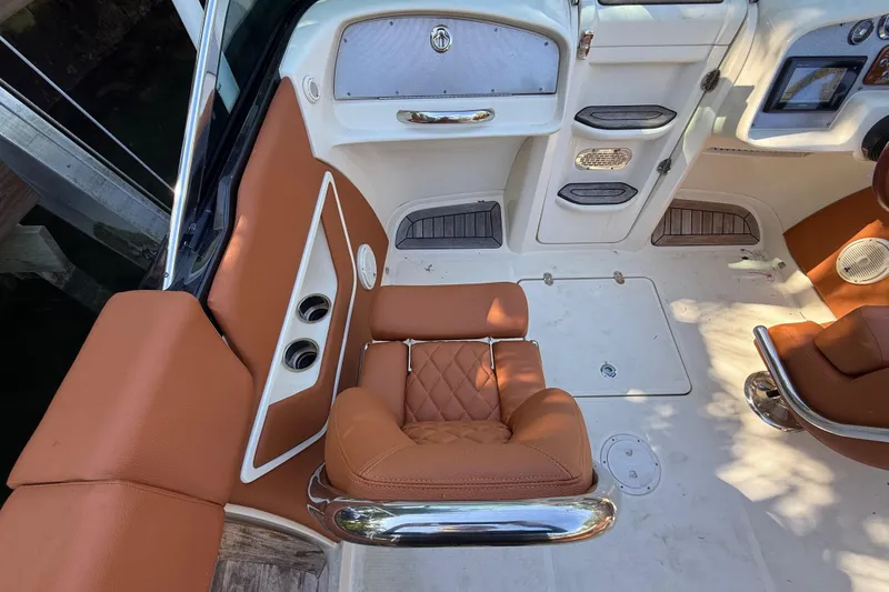Slide: The Image of Interior of a 2018 Chris-Craft Capri 27 with brown leather seats. - 16