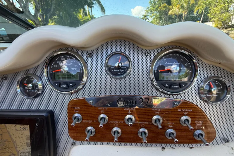 Slide: The Image of Dashboard of 2018 Chris-Craft Capri 27 boat with gauges and controls. - 24