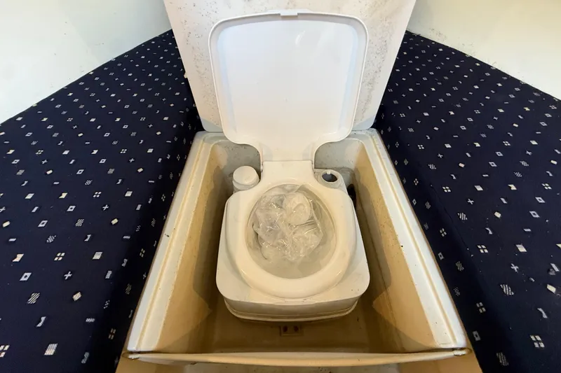 Slide: The Image of 2018 Chris-Craft Capri 27 boat interior with a compact toilet setup. - 35