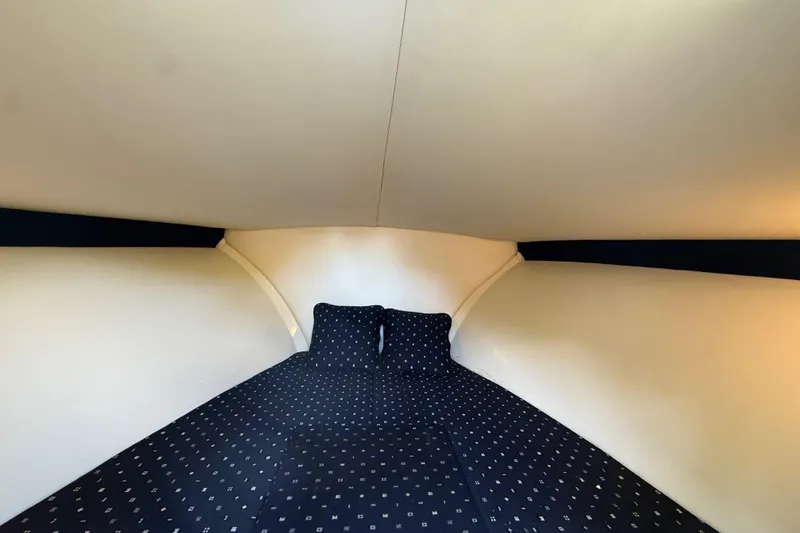 Slide: The Image of 2018 Chris-Craft Capri 27 cabin interior with cozy bedding. - 36