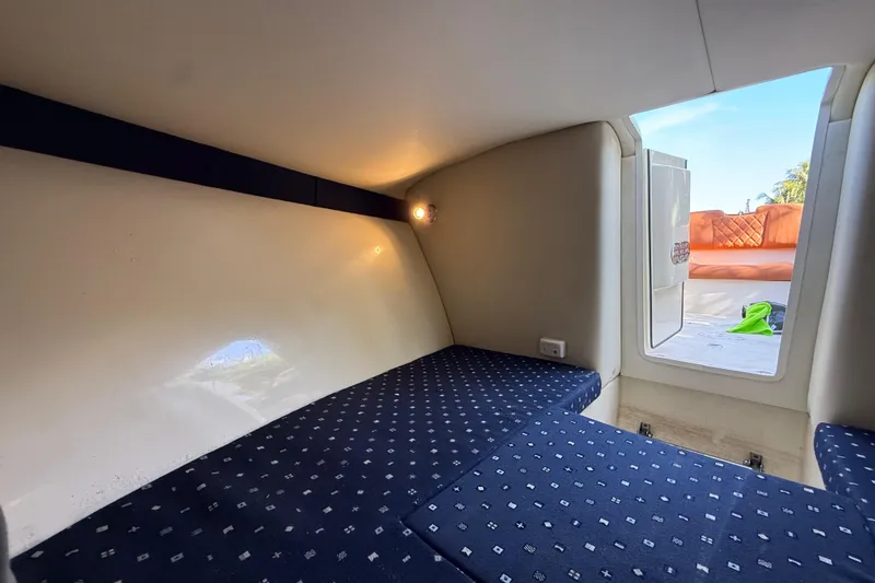 Slide: The Image of 2018 Chris-Craft Capri 27 cabin interior with patterned seating and open hatch. - 40