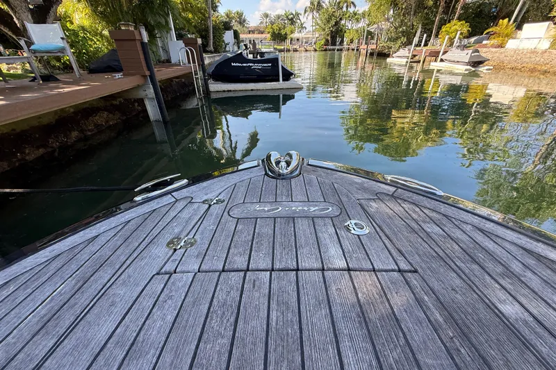Slide: The Image of 2018 Chris-Craft Capri 27 boat docked in a serene, tropical canal setting. - 45