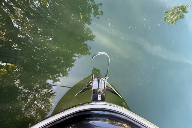 Slide: The Image of 2018 Chris-Craft Capri 27 boat bow reflecting on calm water. - 46