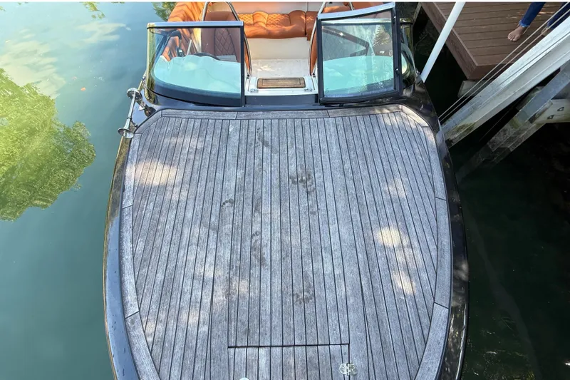 Slide: The Image of 2018 Chris-Craft Capri 27 boat with wooden deck at dock. - 48