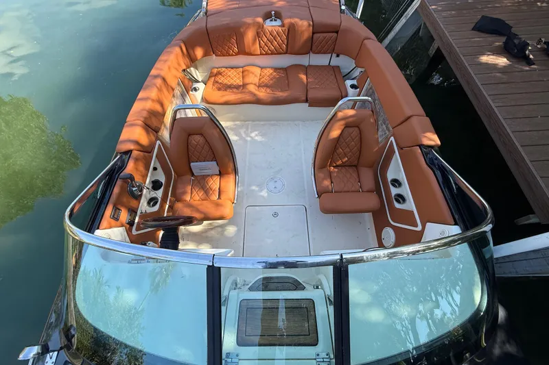 Slide: The Image of 2018 Chris-Craft Capri 27 boat with luxurious tan leather seating and sleek design. - 50