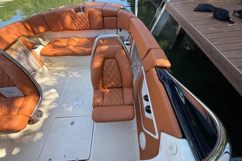 Slide: The Image of Interior of a 2018 Chris-Craft Capri 27 with brown leather seating. - 51