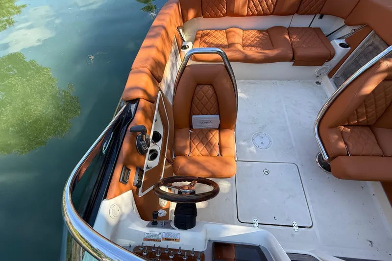 Slide: The Image of Interior of a 2018 Chris-Craft Capri 27 with brown leather seats. - 52