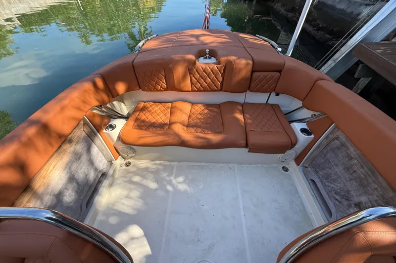 Slide: The Image of 2018 Chris-Craft Capri 27 boat interior with tan leather seating and elegant design. - 53