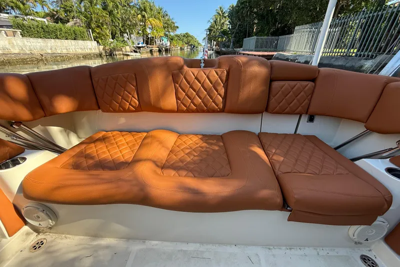 Slide: The Image of Luxurious seating on 2018 Chris-Craft Capri 27 boat with quilted brown upholstery. - 55