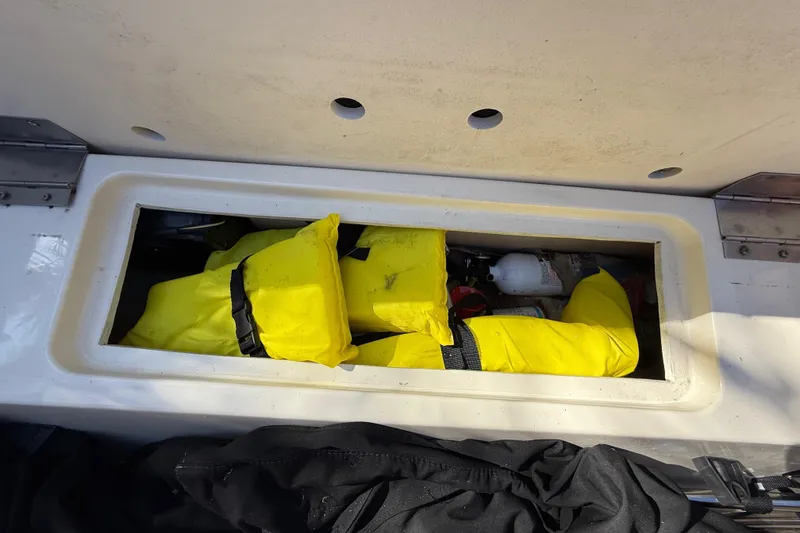 Slide: The Image of Storage compartment in Chris-Craft Capri 27 boat with yellow life jackets. - 60