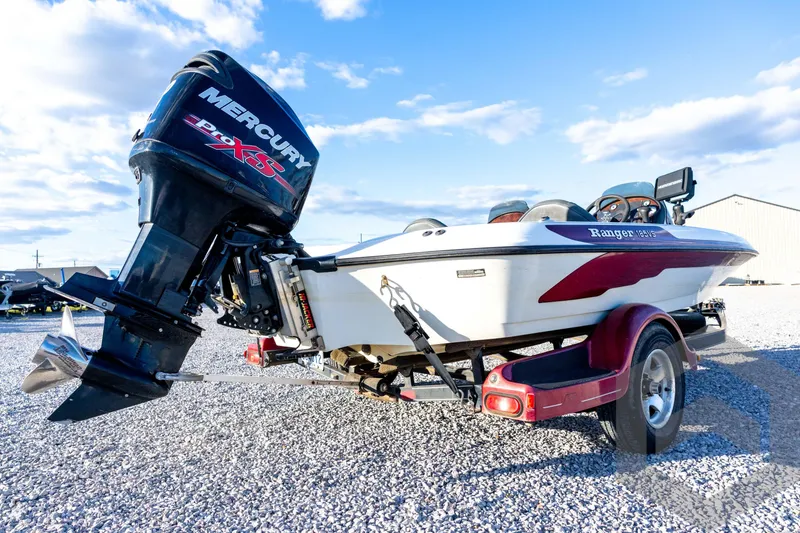 Slide: The Image of 2002 Ranger 185 VS boat with Mercury Pro XS engine on trailer, parked on gravel. - 14