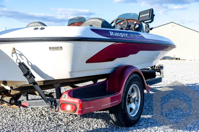 Slide: The Image of 2002 Ranger 185 VS boat on trailer, parked on gravel, sunny day. - 15