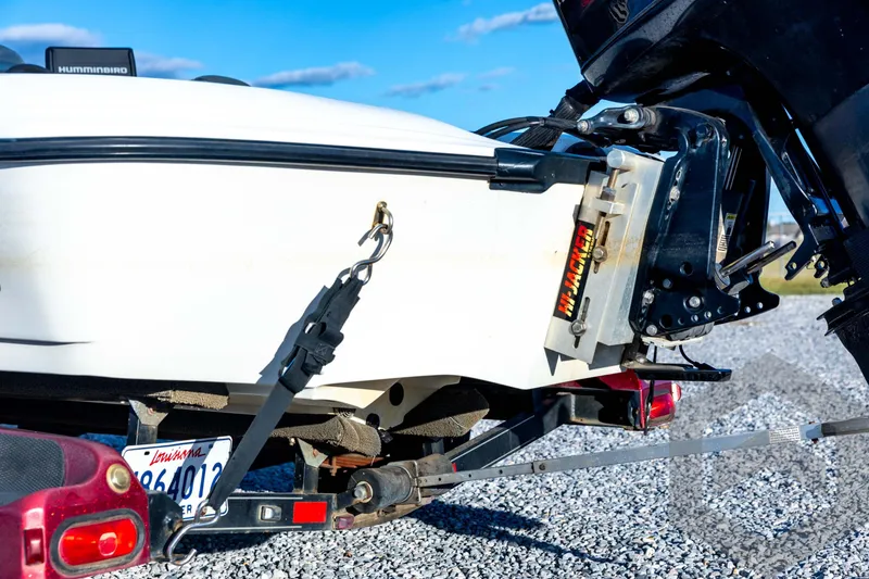 Slide: The Image of 2002 Ranger 185 VS boat trailer hitch with Hi-Jacker, parked on gravel. - 19