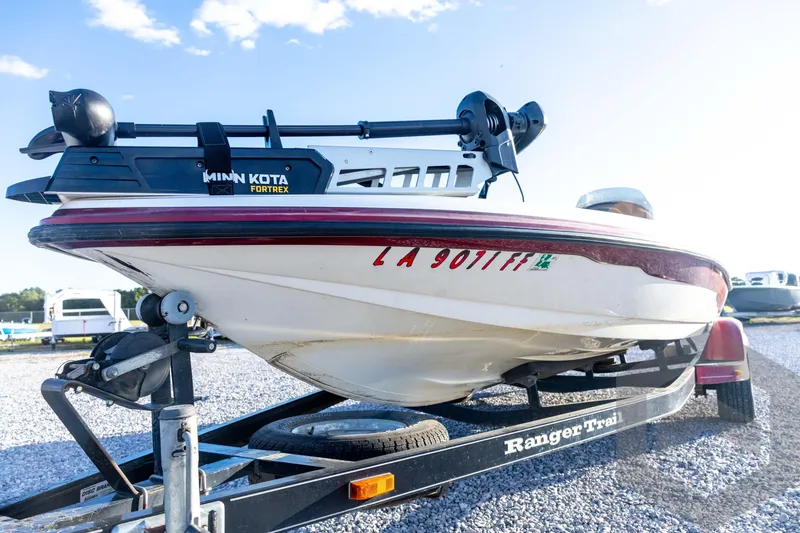 Slide: The Image of 2002 Ranger 185 VS boat on trailer with Minn Kota Fortrex motor, parked on gravel. - 22