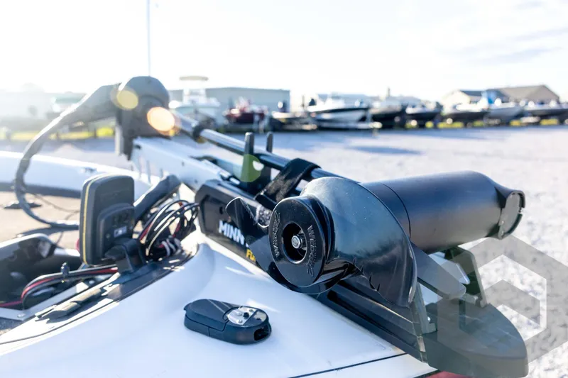 Slide: The Image of 2002 Ranger 185 VS boat with Minn Kota trolling motor and control panel in a sunny marina. - 24