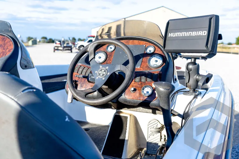 Slide: The Image of 2002 Ranger 185 VS boat dashboard with Humminbird fish finder and steering wheel. - 26