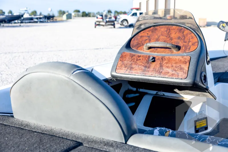 Slide: The Image of 2002 Ranger 185 VS boat interior with wood panel dashboard and gray seating. - 27