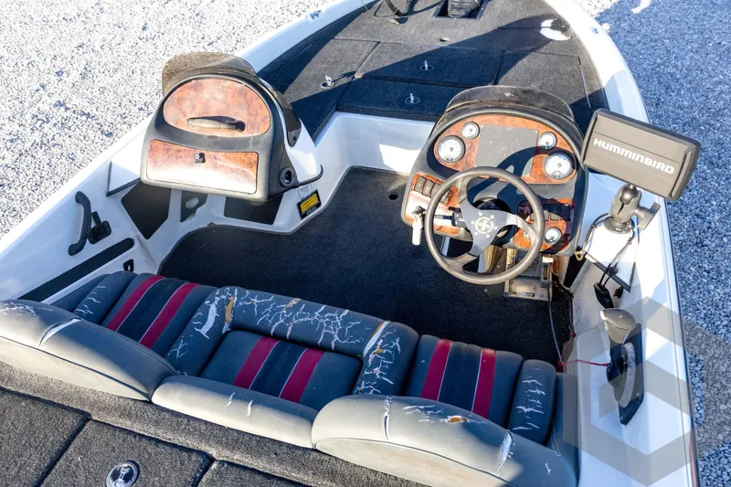 Slide: The Image of 2002 Ranger 185 VS boat interior with steering wheel, seats, and Humminbird fish finder. - 39