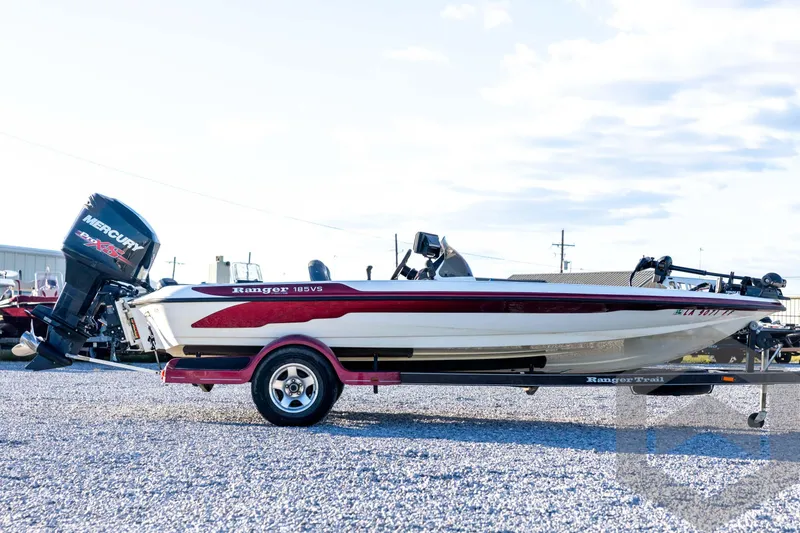 Slide: The Image of 2002 Ranger 185 VS boat with Mercury engine on trailer, parked on gravel. - 4