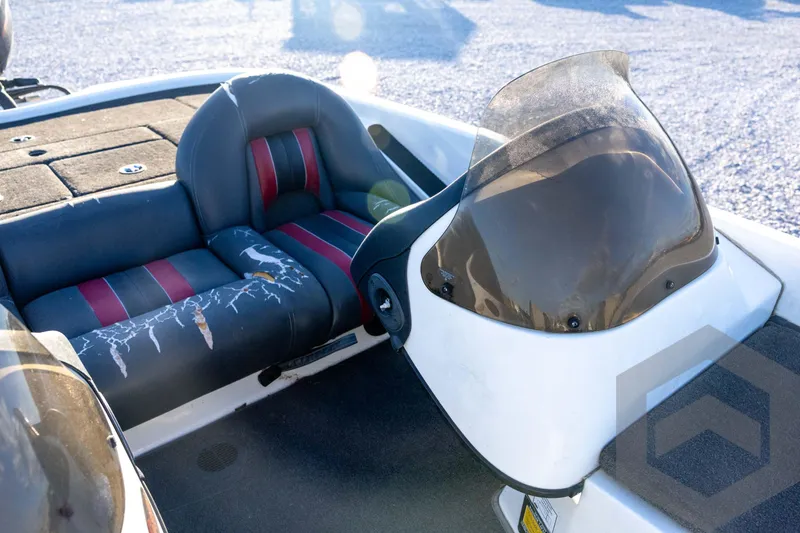 Slide: The Image of 2002 Ranger 185 VS boat interior with worn seats and windshield. - 42