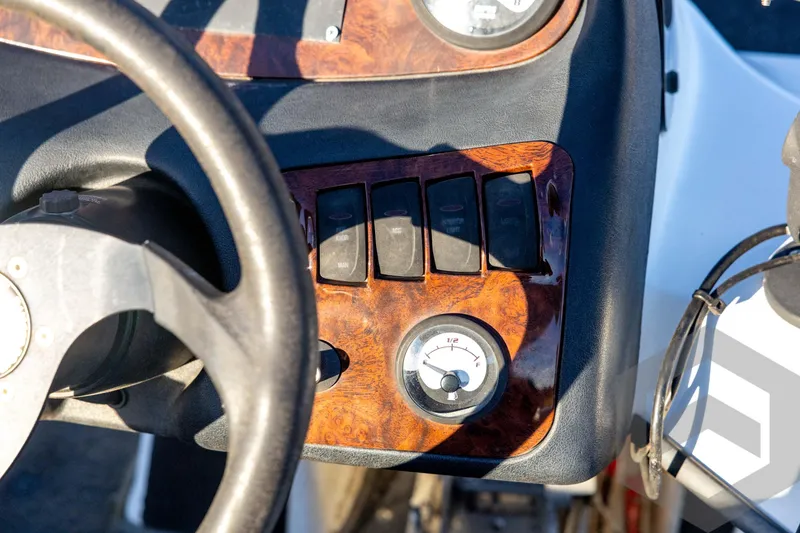 Slide: The Image of 2002 Ranger 185 VS boat dashboard with steering wheel and control switches. - 45