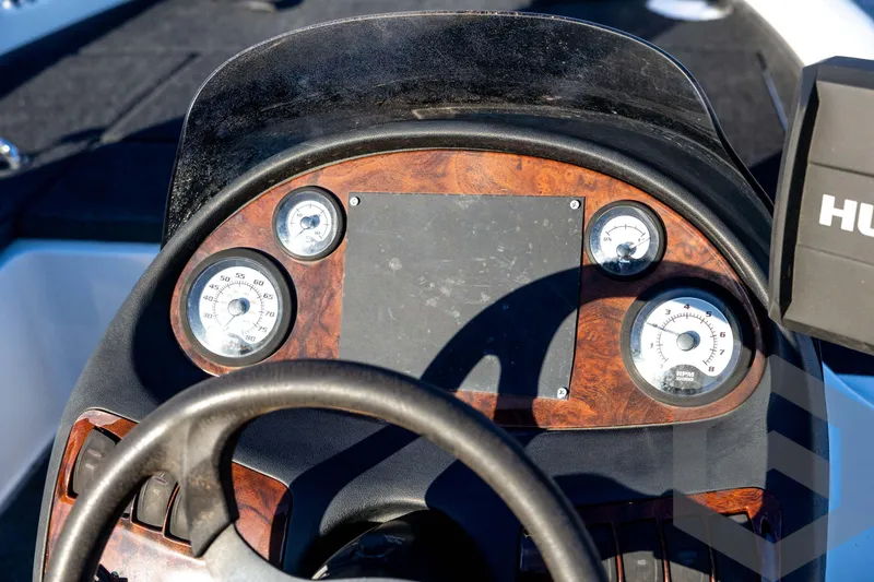 Slide: The Image of Dashboard of a 2002 Ranger 185 VS boat with gauges and steering wheel. - 46