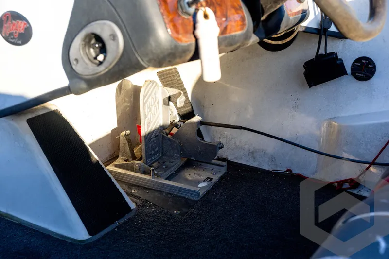 Slide: The Image of 2002 Ranger 185 VS boat interior showing foot pedal and steering console. - 47