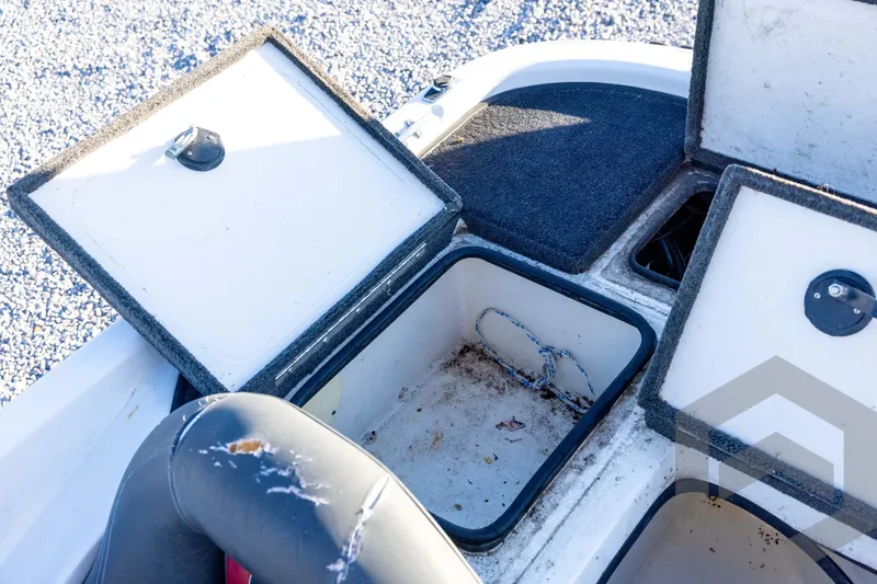Slide: The Image of Open storage compartments on a 2002 Ranger 185 VS boat, showing interior details. - 53