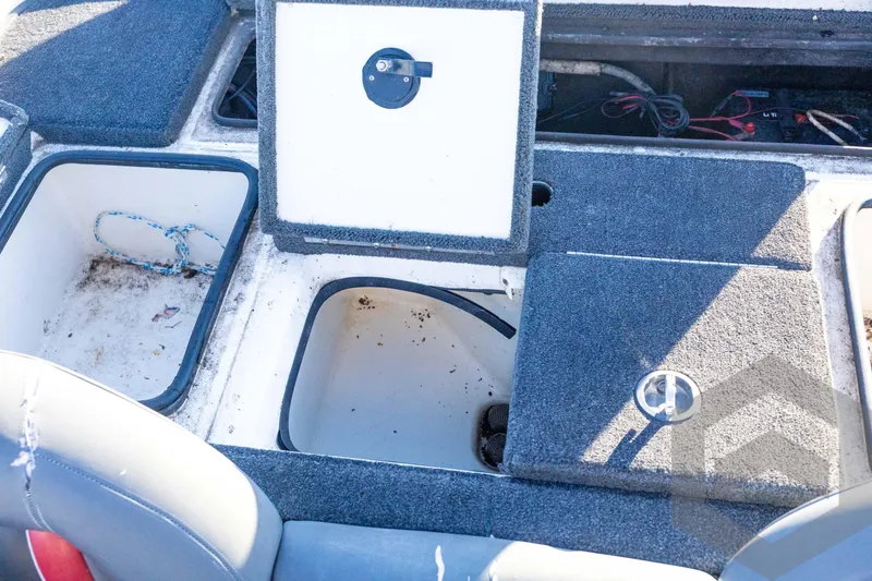 Slide: The Image of 2002 Ranger 185 VS boat storage compartments with open hatches and visible wiring. - 54