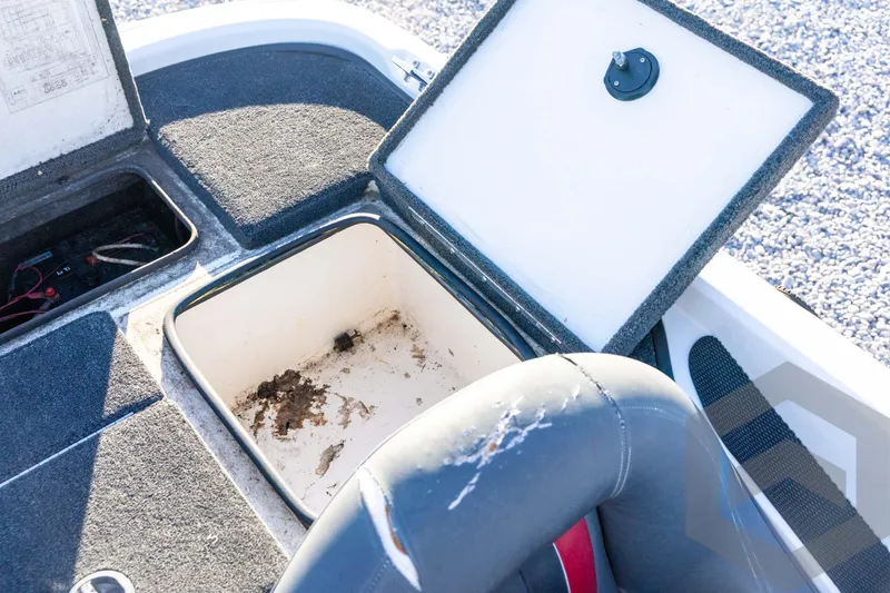 Slide: The Image of Open storage compartment in 2002 Ranger 185 VS boat, showing interior details. - 55
