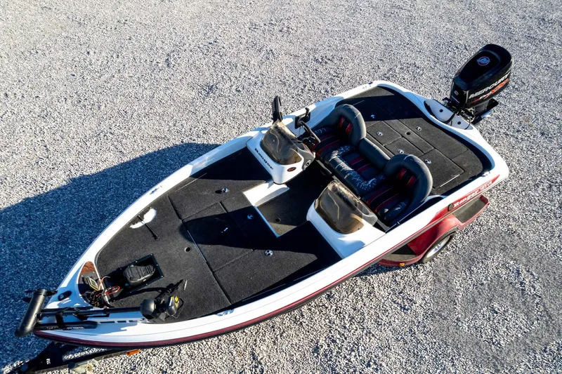 Slide: The Image of 2002 Ranger 185 VS boat on gravel, featuring dual seats and a Mercury outboard motor. - 64