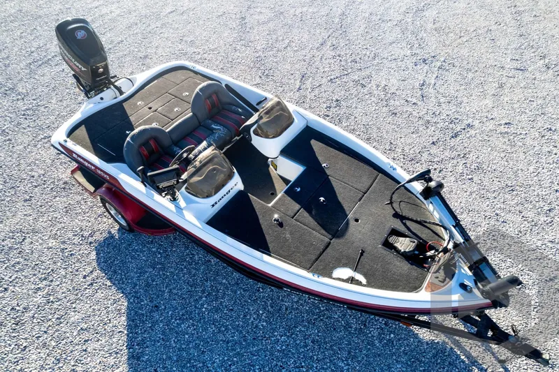 Slide: The Image of 2002 Ranger 185 VS boat on gravel, featuring dual seats and a motor. - 66