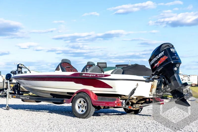 Slide: The Image of 2002 Ranger 185 VS boat with Mercury engine on a trailer, parked outdoors. - 7