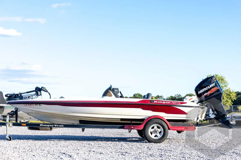 Slide: The Image of 2002 Ranger 185 VS boat with Mercury engine on trailer, parked on gravel. - 8