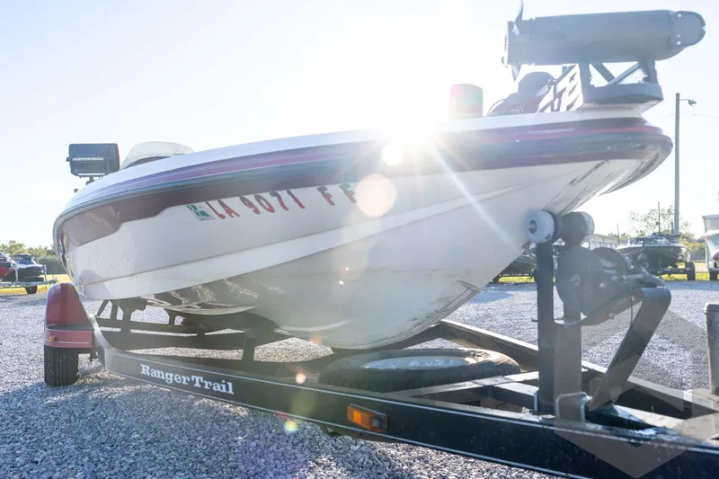 Slide: The Image of 2002 Ranger 185 VS boat on trailer, sunlit, parked on gravel. - 9