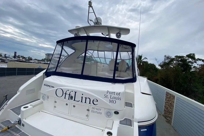 Slide: The Image of 2006 Cruisers Yachts 520 Express docked, rear view with "OffLine" name and St. Louis port. - 12