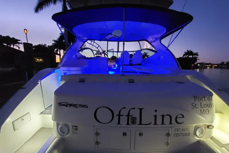 Slide: The Image of 2006 Cruisers Yachts 520 Express at dusk, illuminated with blue lights, docked in St. Louis. - 13