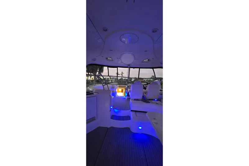 Slide: The Image of Interior of 2006 Cruisers Yachts 520 Express with blue ambient lighting. - 16
